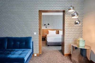 a hotel room with a bed and a blue couch at The Marmara Pera in Istanbul