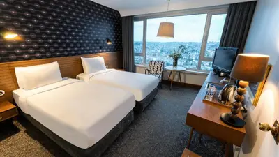 a hotel room with two beds and a desk at The Marmara Pera in Istanbul