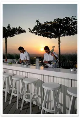a man standing at a bar with a bartender at The Marmara Pera in Istanbul