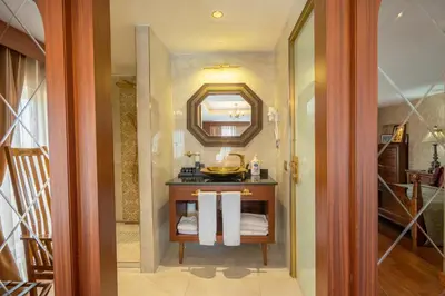 a bathroom with a vanity with a mirror and towels at The Green Park Taksim in Istanbul
