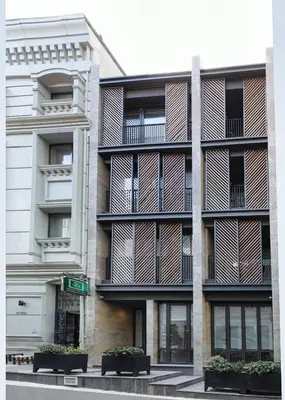 an apartment building with balconies and a street sign at Galata Rasso Hotel in Istanbul