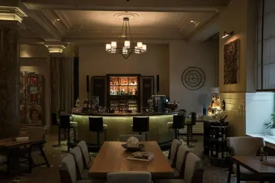 a bar in a restaurant with tables and chairs at The Bank Hotel Istanbul, a Member of Design Hotels in Istanbul
