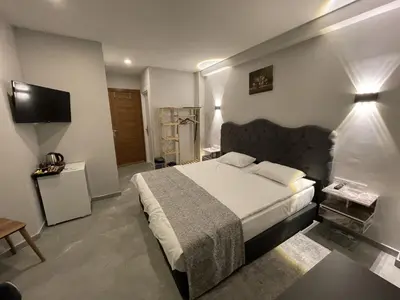 a bedroom with a large bed and a television at Turna Hotel in Istanbul