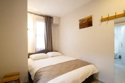 a bedroom with a bed in a room with a window at Turna Hotel in Istanbul