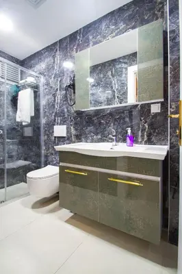 a bathroom with a sink and a toilet and a mirror at Turna Hotel in Istanbul