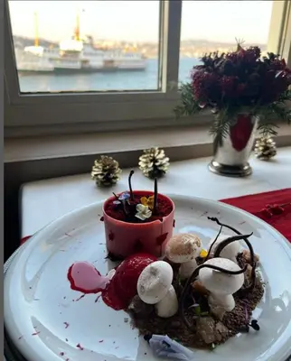 a plate of food on a table next to a window at A'jia Hotel in Istanbul