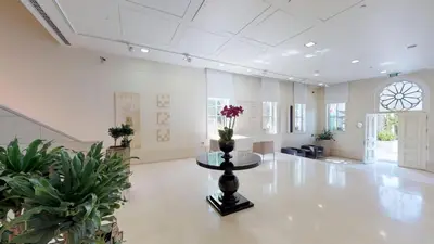 a large white room with a table with flowers on it at A'jia Hotel in Istanbul