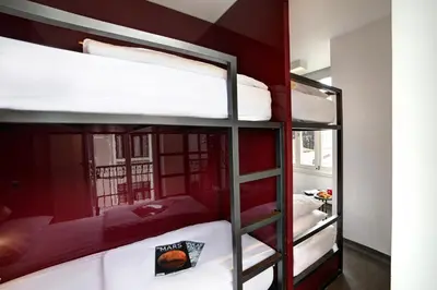 two bunk beds in a room with red walls at The Central House Istanbul Taksim in Istanbul