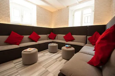 a living room with a couch and red pillows at The Central House Istanbul Taksim in Istanbul