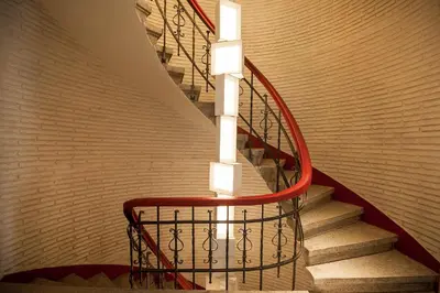 a spiral staircase with a red railing in a building at The Central House Istanbul Taksim in Istanbul