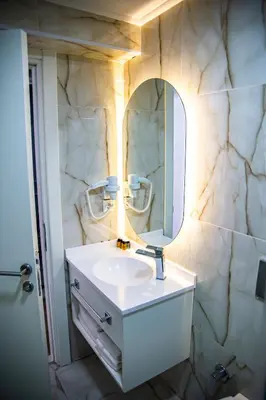 a bathroom with a sink and a mirror at Silvana Hotel in Istanbul
