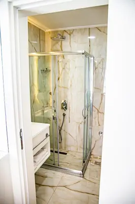 a shower with a glass door in a bathroom at Silvana Hotel in Istanbul