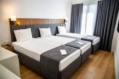 a hotel room with two beds and a window at Silvana Hotel in Istanbul
