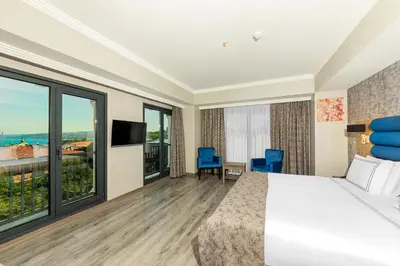 a hotel room with a bed and large windows at Demiray Hotel Old City in Istanbul