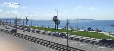 a highway with cars on it next to the water at fafsuitehome in Istanbul