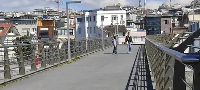 a man and a woman walking on a bridge at fafsuitehome in Istanbul