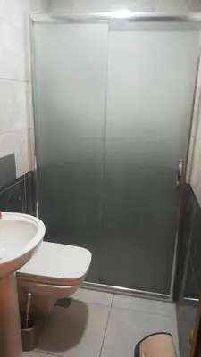a bathroom with a shower with a toilet and a sink at Mr Lion Kumkapı Otel in Istanbul