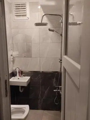 a bathroom with a toilet and a sink and a shower at Mr Lion Kumkapı Otel in Istanbul