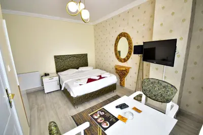 a hotel room with two beds and a television at LOCA Suit LİFE AİRPORT HOTEL in Istanbul
