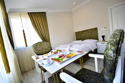 a hotel room with a table with food on it at LOCA Suit LİFE AİRPORT HOTEL in Istanbul