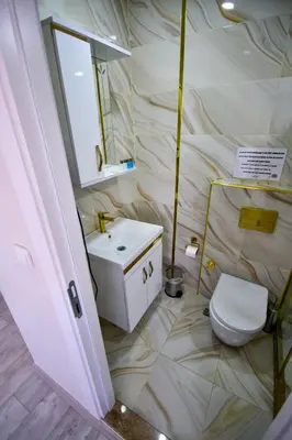 a bathroom with a toilet and a sink at LOCA Suit LİFE AİRPORT HOTEL in Istanbul
