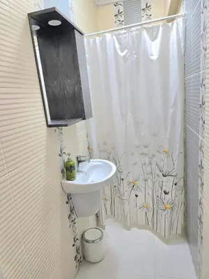 a bathroom with a sink and a shower curtain at Osmanbey sweet homes in Istanbul