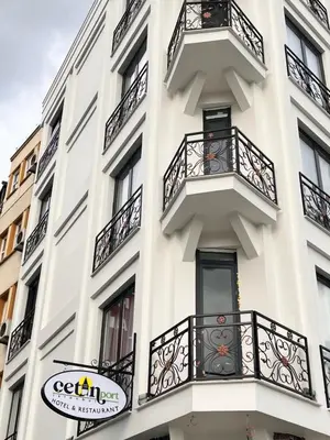 a white building with balconies and a sign on it at Cetin Port Hotel in Istanbul