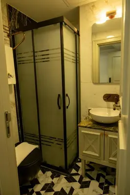 a bathroom with a shower and a sink at Cetin Port Hotel in Istanbul