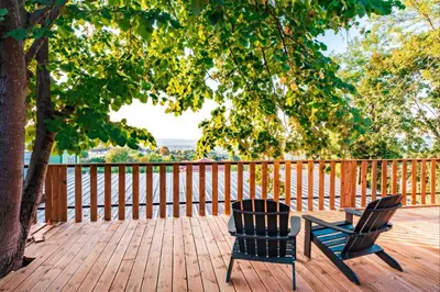 two chairs sitting on a wooden deck with a tree at Kartepe LOFT in Kartepe