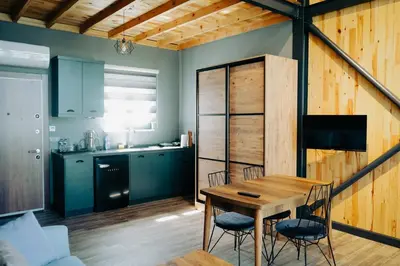 a kitchen and dining room with a wooden table and chairs at Kartepe LOFT in Kartepe
