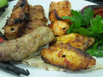 a plate of food with fried food and a salad at Çınarpark Hotel in Korfez