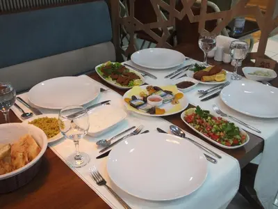a table with plates and bowls of food on it at Çınarpark Hotel in Korfez