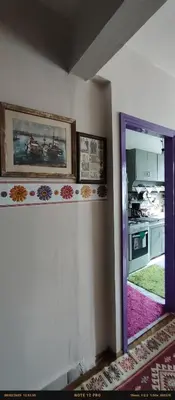 a room with a door and a kitchen with a mirror at Nur home 2 in Istanbul