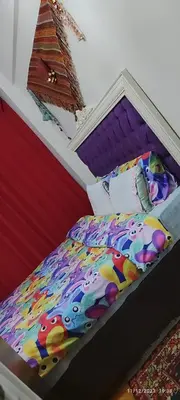 a bed with a colorful comforter on it at Nur home 2 in Istanbul