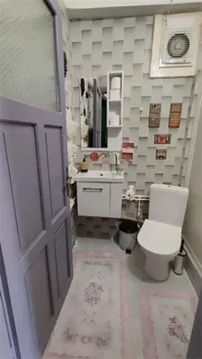 a bathroom with a toilet and a sink and a door at Nur home 2 in Istanbul