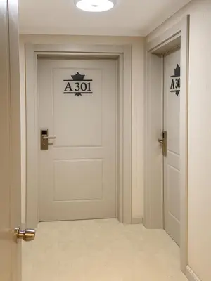 a white door in a hallway with a sign on it at Imagine Istanbul - Sultanahmet in Istanbul