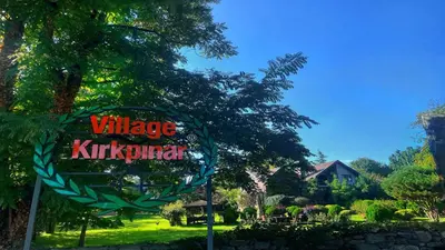 a sign for a village kirkitschrift in a park at Villa Kirkpinar Sapanca in Sapanca