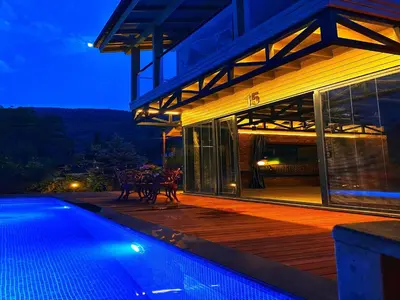a house with a swimming pool at night at Villa Kirkpinar Sapanca in Sapanca