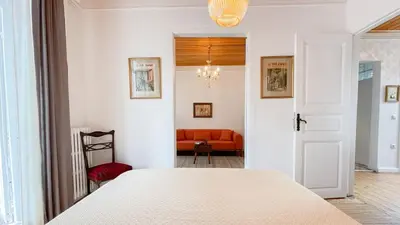a bedroom with a white bed and a red couch at Stanbul House in Istanbul