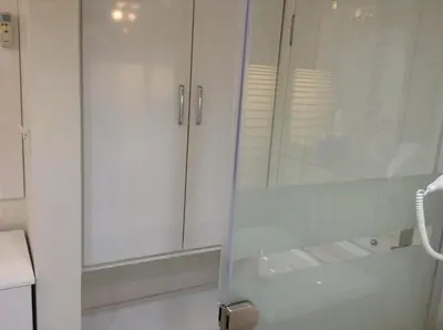 a bathroom with white cabinets and a sink at Mola Hotel in Marmara Adasi