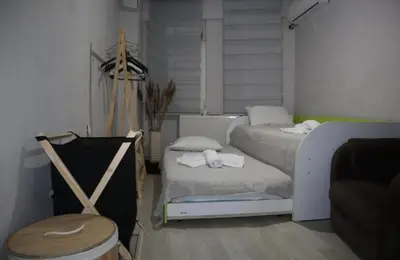 a bedroom with two beds and a chair in it at Pink OLD CITY 1 in Istanbul