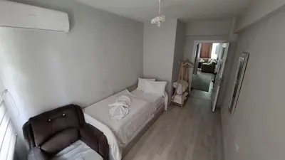 a small bedroom with a bed and a chair at Pink OLD CITY 1 in Istanbul