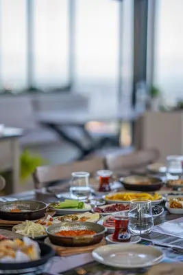 a table with many plates of food on it at Alya Kartepe Villa Hotel in Kocaeli