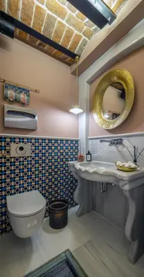 a bathroom with a sink and a toilet and a mirror at Hotel Turkish House in Istanbul