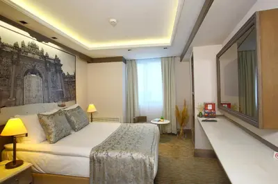 a hotel room with a bed and a large window at AHC Ayasofya Hotel - Special Class in Istanbul