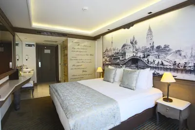 a hotel room with a bed and a painting on the wall at AHC Ayasofya Hotel - Special Class in Istanbul