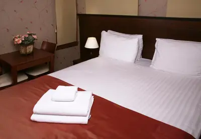 a bedroom with a bed with two towels on it at Sultanahmet Suites in Istanbul