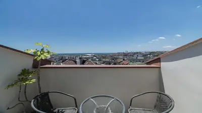 a balcony with two chairs and a view of a city at Holiday Inn Istanbul Old City by IHG in Istanbul