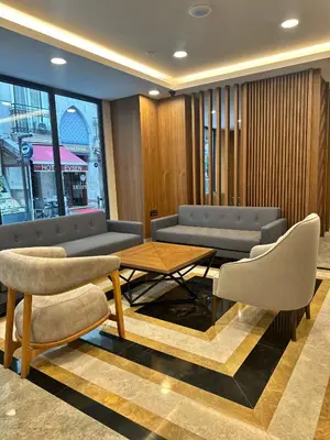 a living room with couches and a table and chairs at Hotel Sapphire in Istanbul