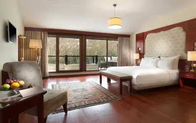 a bedroom with a bed and a table and a couch at Sirkeci Mansion in Istanbul